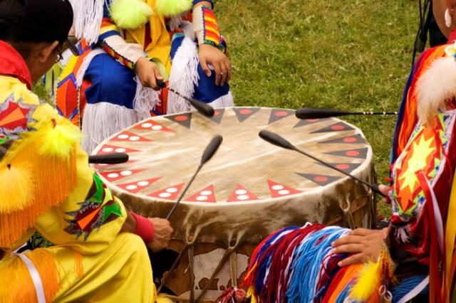 People Hitting a Drum